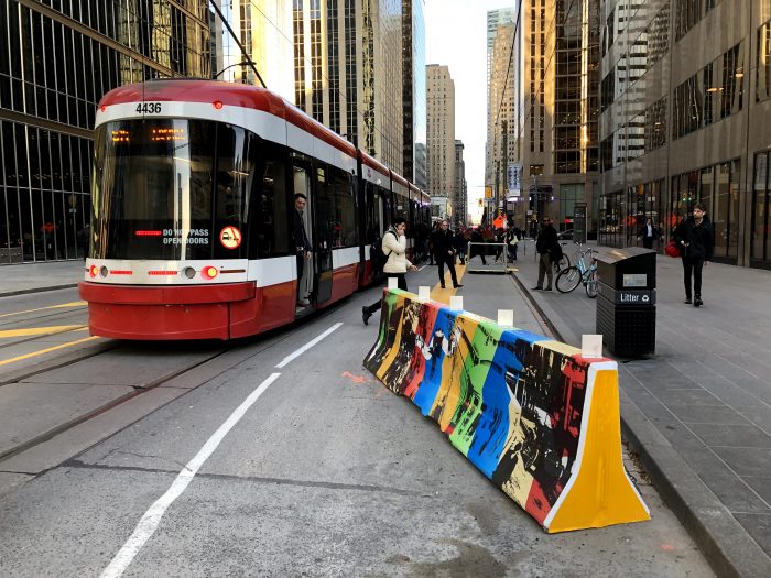 New far-side stops with a temporary curb-extension mean passengers no longer have to walk through a traffic lane to get on and off the streetcar. (Photo: Alex Gaio)